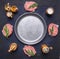 Raw homemade burgers Beef, laid out around a vintage pan with spices and herbs on blue rustic wooden background with space for t