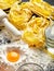 Raw homemade fettucine, raw egg yolk and flour on table