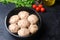 Raw homemade steamed meatballs with chicken and buckwheat. black concrete background. place for text. copyspace