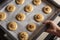 Raw honey biscuits with walnuts on a baking sheet with parchment paper, ready for baking.