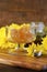 Raw honeycomb with liquid honey in glass bowl with serving dipper.