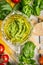 Raw Ingredients for basil pesto spaghetti on rustic wooden