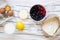 Raw ingredients: berries, flour, eggs, butter, lemon, water, sugar, salt for cooking berry pie on white wooden background, top vie