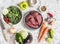 Raw ingredients for cooking lunch - beef meat and vegetables on a light background