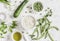 Raw ingredients - rice, zucchini, green beans and peas, olive oil on a light background. Cooking background.