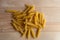 Raw italian pasta mixed on wooden desk. Natural light