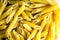 Raw italian penne rigate macaroni pasta inside clear packaging