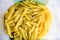 Raw italian penne rigate macaroni pasta inside clear packaging