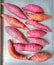 Raw Japanese sweet potatoes on an aluminum tray