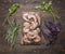 Raw king prawns with herbs on a cutting board on wooden rustic background top view close up