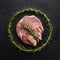 Raw lamb adorned with rosemary, elegant presentation on black backdrop