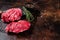 Raw Lamb fillet steaks with herbs and spices, uncooked mutton meat. Dark background. Top view. Copy space