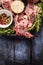 Raw lamb meat with peppercorn, rosemary and garlic on blue rustic wooden table