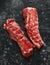 Raw lamb shoulder fillets on black table, background