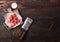 Raw lean diced casserole beef pork steak on chopping board with vintage meat hatchet on wooden background. Salt and pepper with