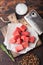 Raw lean diced casserole beef pork steak on chopping board with vintage meat hatchet on wooden background. Salt and pepper with