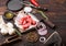 Raw lean diced casserole beef pork steak with vintage meat hatchet and fork on wooden background. Salt and pepper with fresh