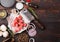 Raw lean diced casserole beef pork steak with vintage meat hatchet and fork on wooden background. Salt and pepper with fresh