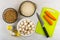 Raw lentils, rice in bowls, carrot, knife on cutting board, mush