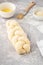 Raw loaf of challah Jewish bread on a light background. Copy space.