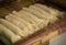 Raw lumpia in row on seller traditional food from indonesia semarang