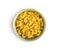 Raw macaroni pasta in bowl. Uncooked rigatoni isolated on white background