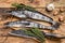 Raw mackerel icefish in a wooden tray. Wooden background. Top view