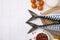 Raw mackerel, tomatoes and peppercorns on white tiled table, flat lay. Space for text