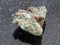 raw Malachite (copper ore) stone on dark