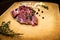 Raw marbled beef on a cutting board. On a black background