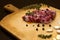 Raw marbled beef on a cutting board. On a black background