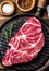 Raw marbled beef steak on grill pan