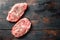 Raw marbled beef steak, top blade organic meat cut. On dark wooden background, top view with space for text