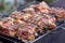 Raw marinaded juicy pork meat in grill grates