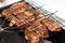 Raw marinaded juicy pork meat in grill grates