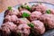 Raw meat balls. Prepared uncooked meat balls in a metal tray.