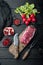 Raw meat beef steak. Black angus prime meat, on wooden cutting board, on black wooden table , Filet mignon cut, top view flat lay