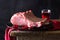 Raw meat on black plate and red towel. Clasic still life