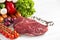 Raw meat, different vegetables and fruits on wooden background.