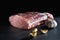 Raw meat. Juicy, appetizing chop with a piece and cut with spices on a gray background