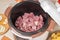 Raw meat in a multicooker pan. Modern, bright multi cooker with products. Cooking stewed potatoes with meat in multicooker. Top