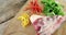 Raw meat, parsley and chopped vegetables on wooden board