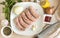Raw meat sausages with spices, top view, onion ,garlic, parsley, knife, lemon