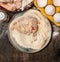 Raw Meat schnitzel preparation in plate with flour, eggs and crumbs on wooden background