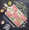 Raw Meat set Pork steaks with herbs and spices on a white cutting board wooden rustic background top view