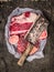 Raw Meat set for soup with vintage cleaver on dark background