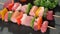 Raw meat skewers on stone plate rotating