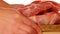 Raw meat on a wooden cutting board.Hands put pieces of chopped meat