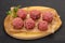 Raw meatball over wooden background