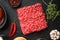 Raw meatballs burger or sandwich ingredients with sesame buns, on black stone background, top view flat lay